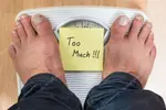 depositphotos_88779354-stock-photo-man-standing-on-weight-scale.jpg