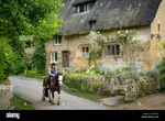 girl-on-horseback-below-thatched-roof-cottage-stanton-the-cotswolds-gloucestersh.jpg